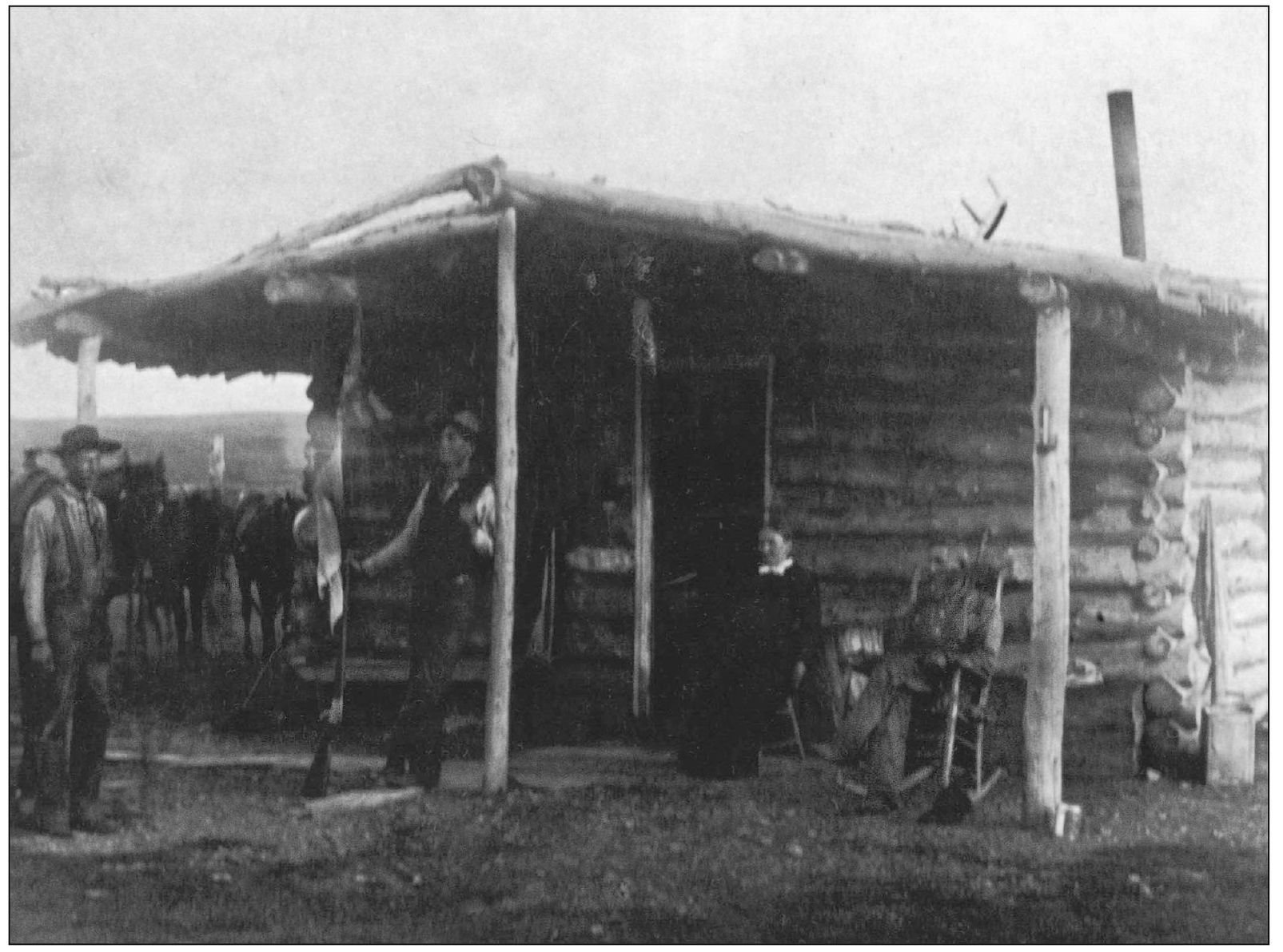 Ezekiel Shelton and his wife Mary sit in front of their log home with its - photo 10