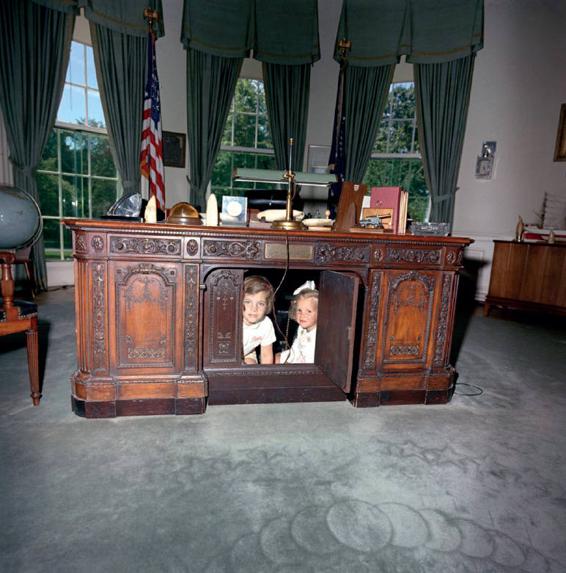 Caroline and Kerry Kennedy peering from the Resolute desk in the Oval Office - photo 13