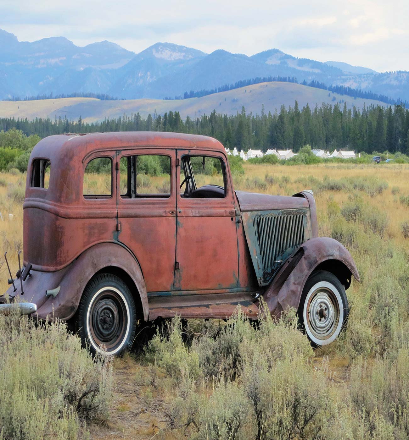 An old car becomes part of the landscape outside West Yellowstone Montana - photo 10