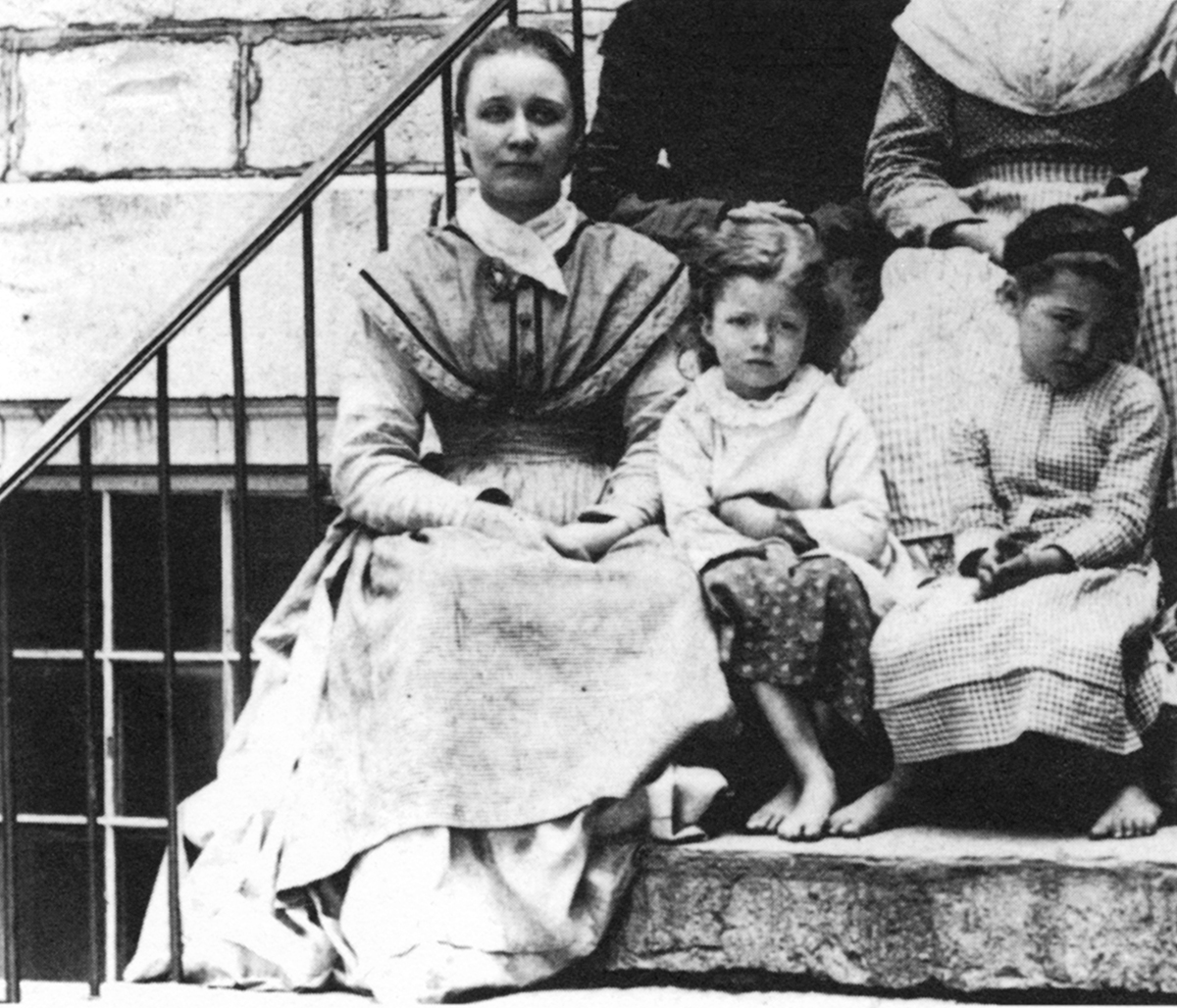 A Sister and two youngsters in the 1870s in a group on the side steps of the - photo 7