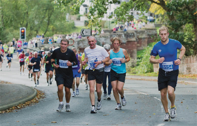 Competitors run up the hill into Farndon during the MBNA Chester Marathon - photo 3