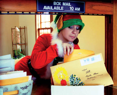 Holly the Elf sorts the Christmas mail in the Original Santa Claus Post Office - photo 11