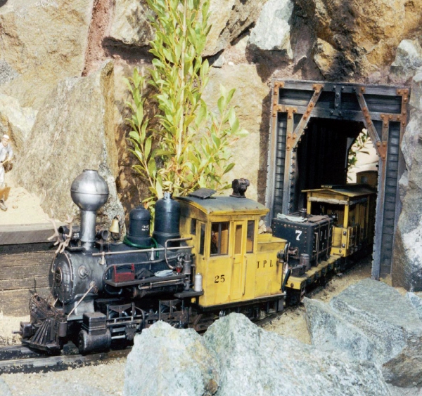 A beautifully detailed and weathered Forney locomotive exits a tunnel on Scott - photo 5