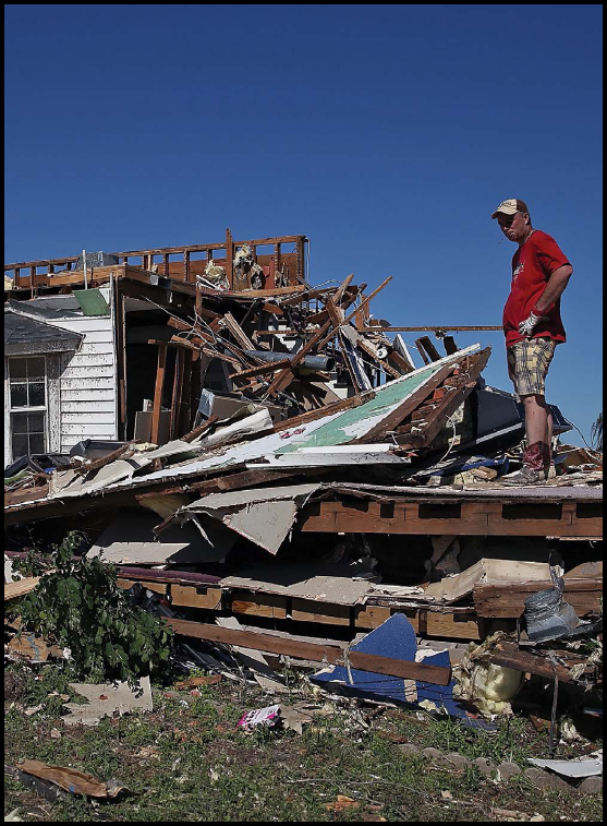 A homeowner sifts through the remains of his property in El Reno Oklahoma A - photo 4