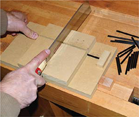 Consistent cuts A small jig made from MDF holds the tubes in place and a - photo 6