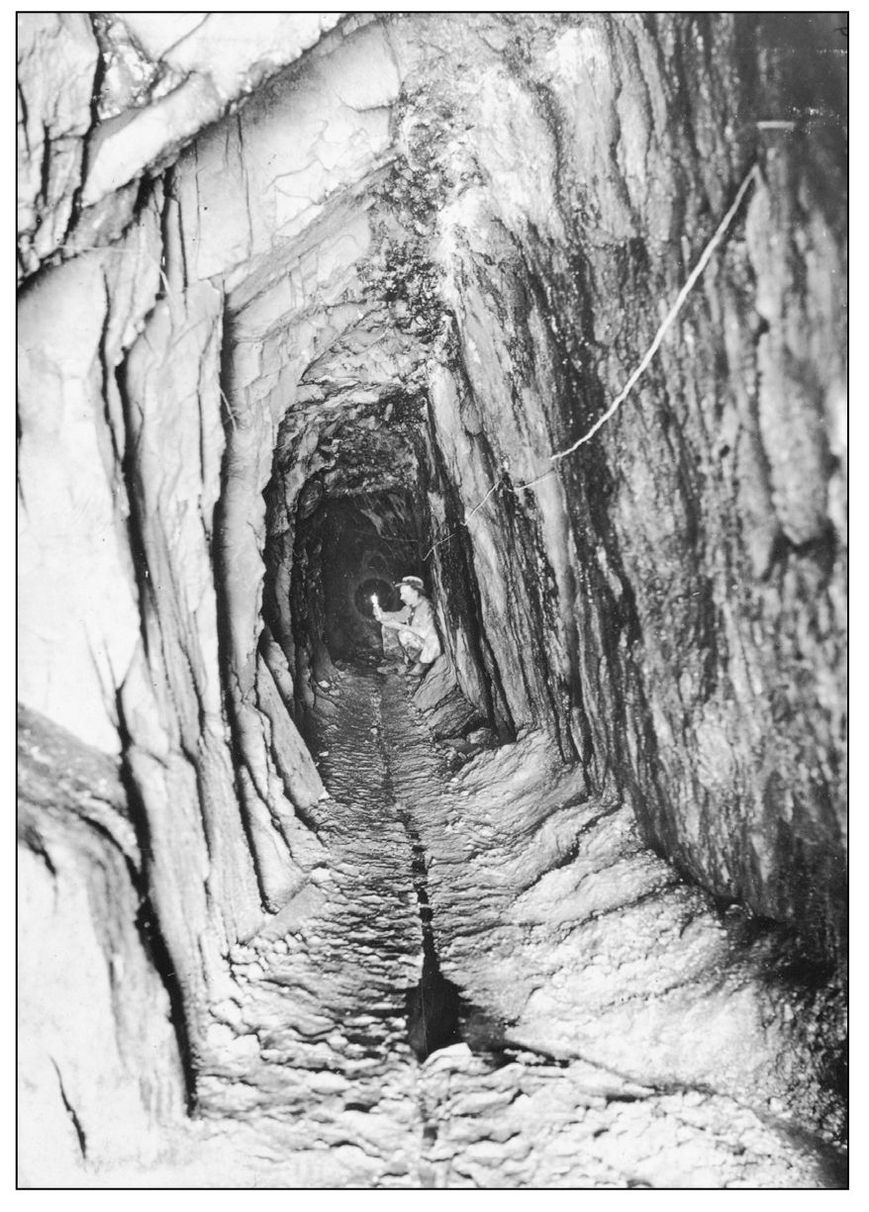 Victor Denny holds a watch and candle inside Tunnel B of the Esther Mines in - photo 6