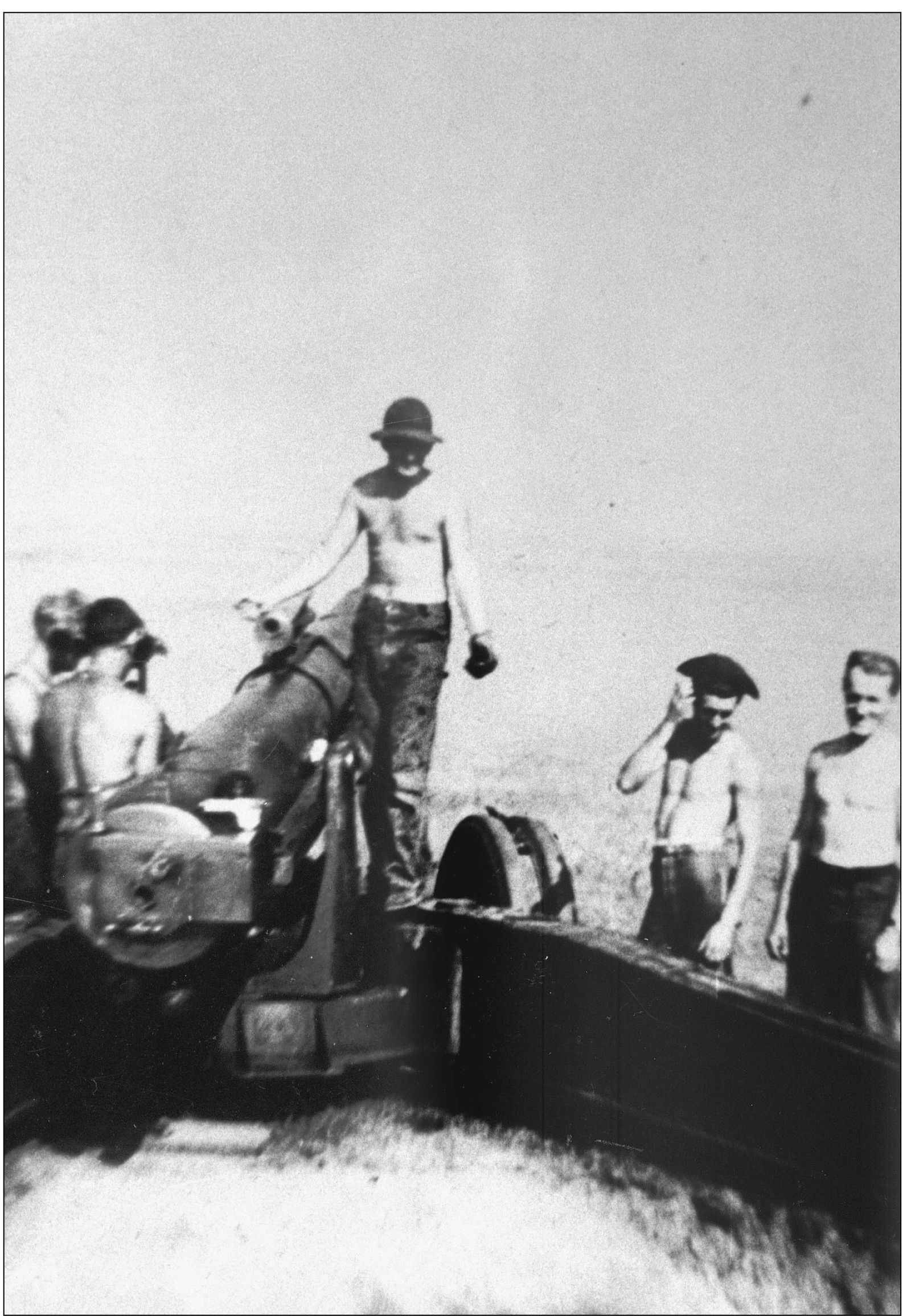 Members of Battery C relax after an arduous artillery drill on a 155mm cannon - photo 15