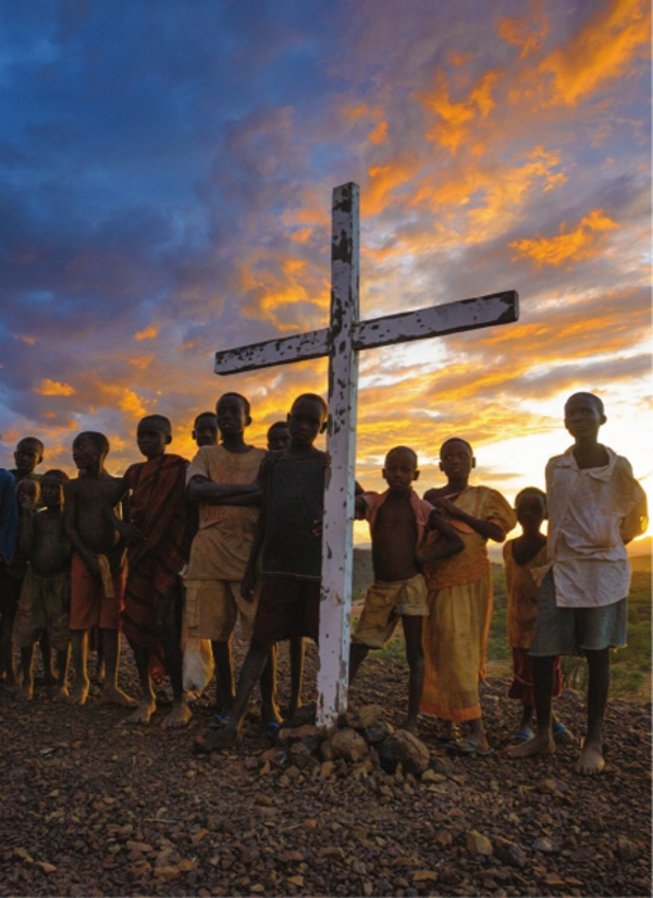 A cross sits atop a hill overlooking a World Vision irrigation project in - photo 2