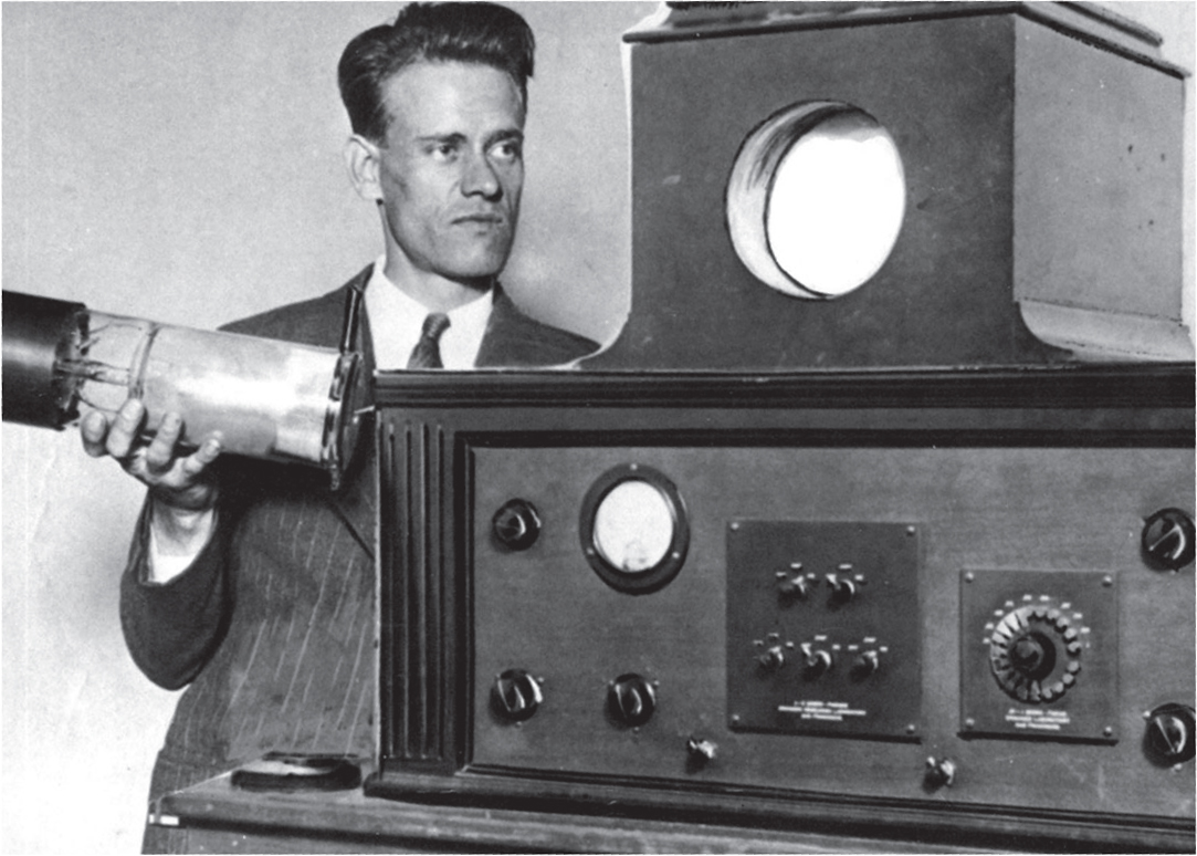 Farnsworth holds his image dissector while standing next to his television He - photo 9