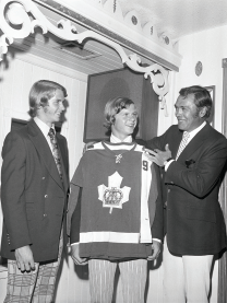 Coach George Armstrong holds up my new Toronto Marlboros jersey in 1972 as - photo 29