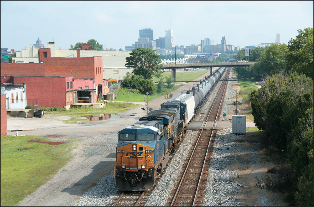 The downtown Akron skyline looms behind a westbound CSX train carrying tank - photo 4