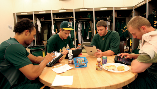 Oakland Athletics players conduct last-minute research on their tablet - photo 3