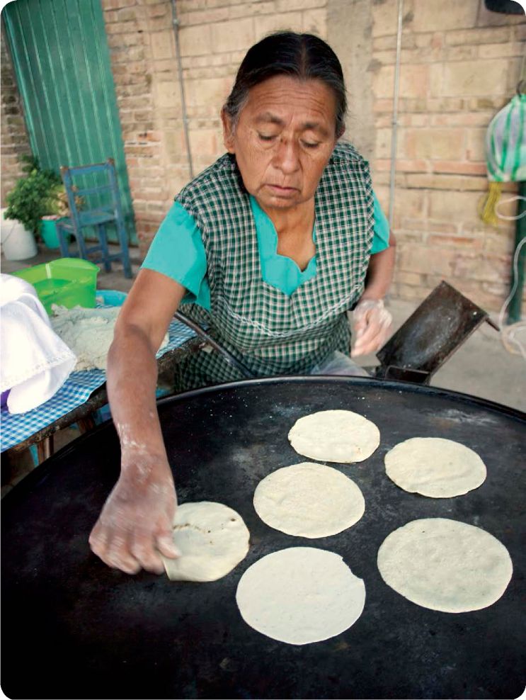 A woman from a rural Mexican town prepares corn tortillas made by hand at the - photo 4