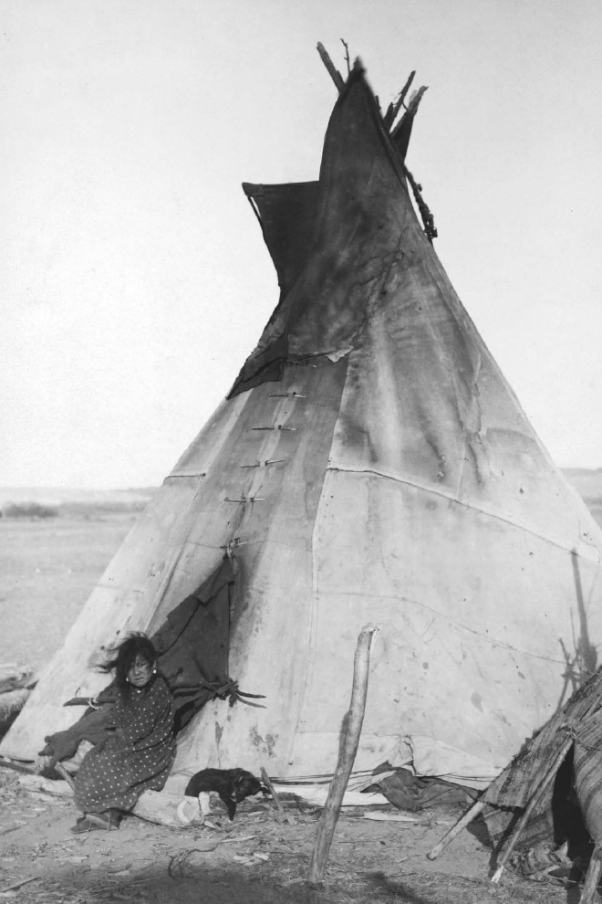 A young Oglala girl sits in front of a tipi near the Pine Ridge reservation - photo 2