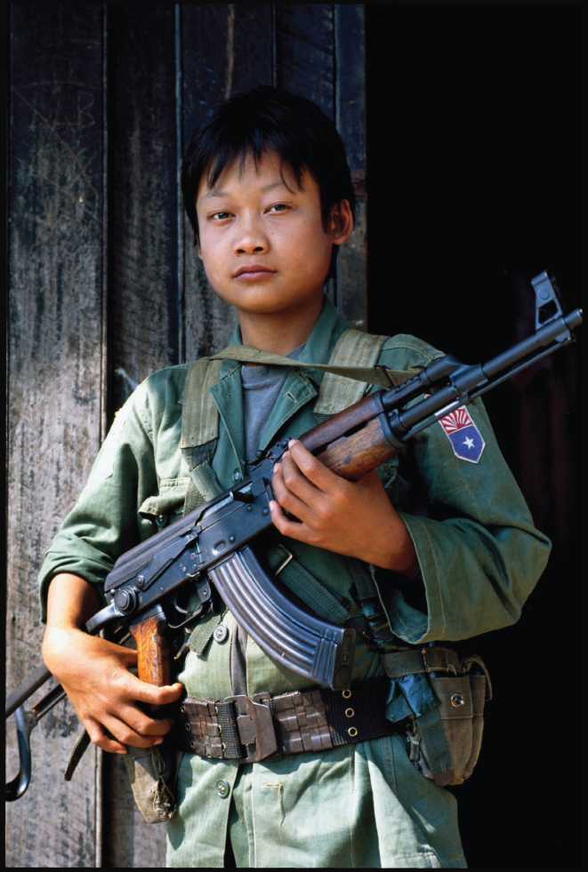 A young Karen National Liberation Army soldier stands guard along the - photo 3