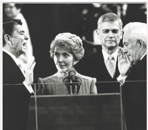 Ronald Reagans wife Nancy looks admiringly at her husband as he is sworn in - photo 7