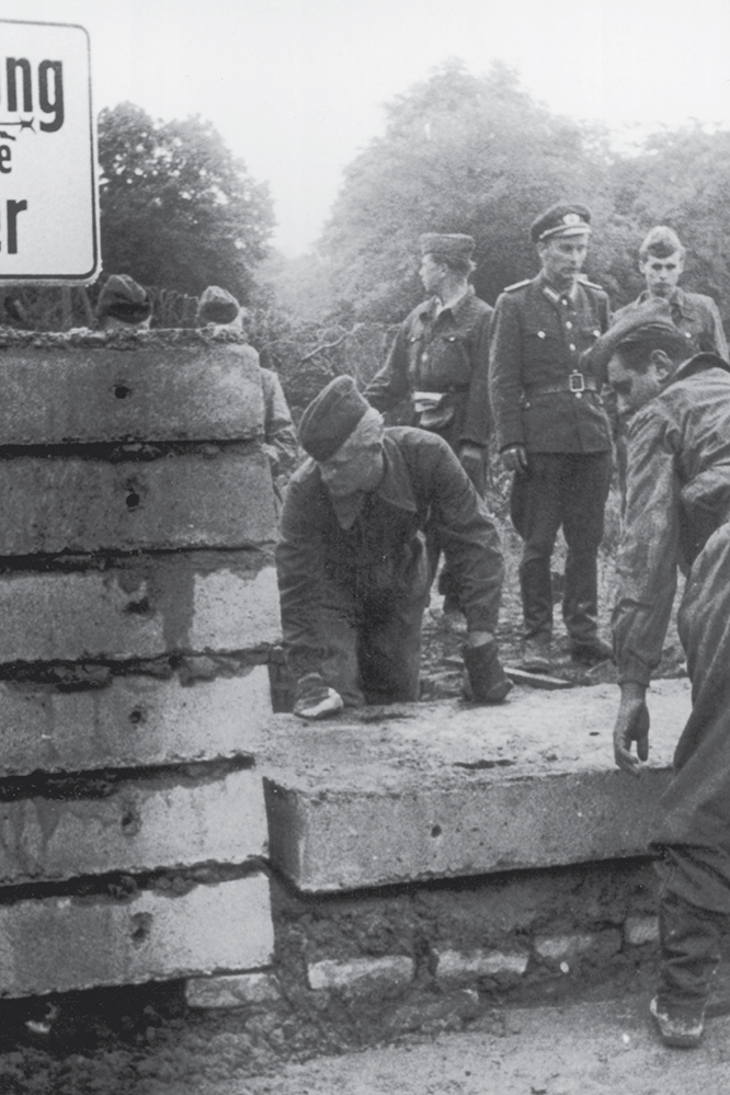 Soldiers lay bricks to build up the Berlin Wall in 1961 Meanwhile the United - photo 3