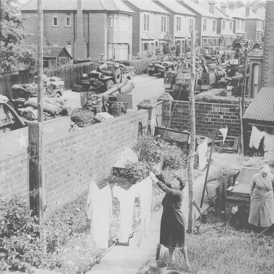 A woman hangs out her laundry in a south coast possibly Southampton garden on - photo 3