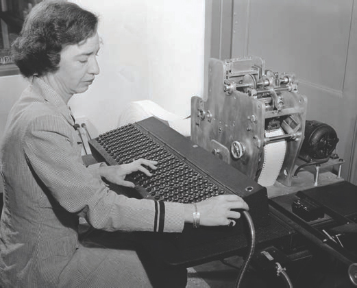 Here Grace Hopper writes a program on punch tape which will then be fed into - photo 5