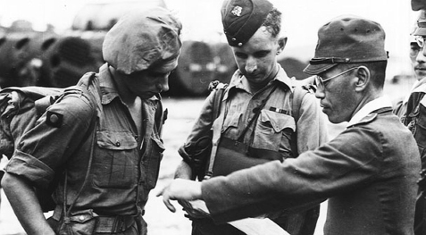 A Japanese officer hands annotated maps to British forces during the liberation - photo 12