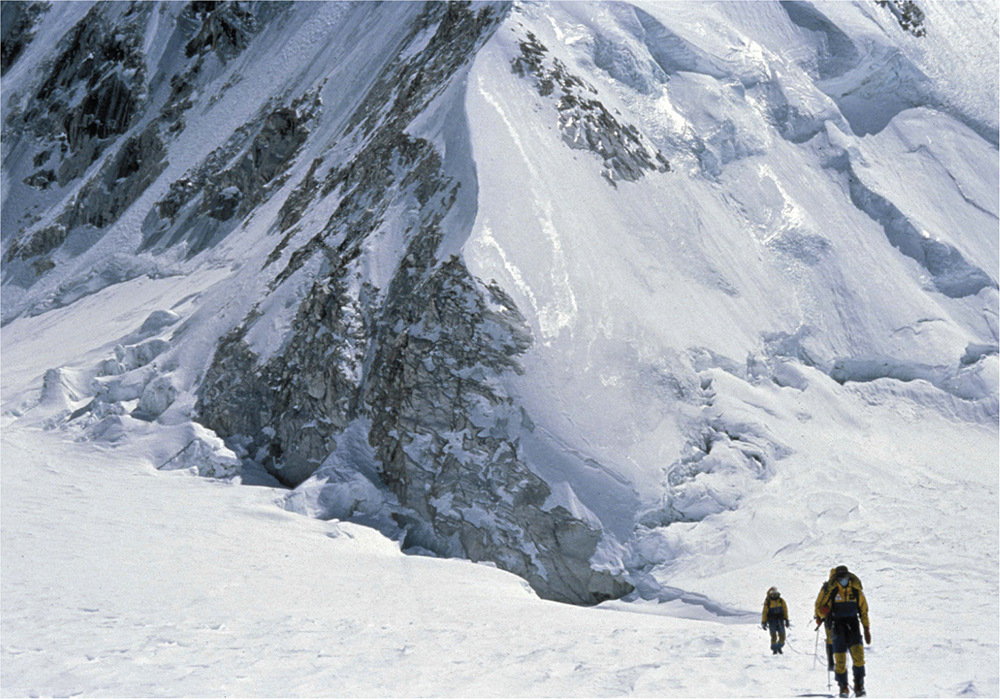 Team members walk down the glacier at 6000 metres Camp Two is hidden in a - photo 6