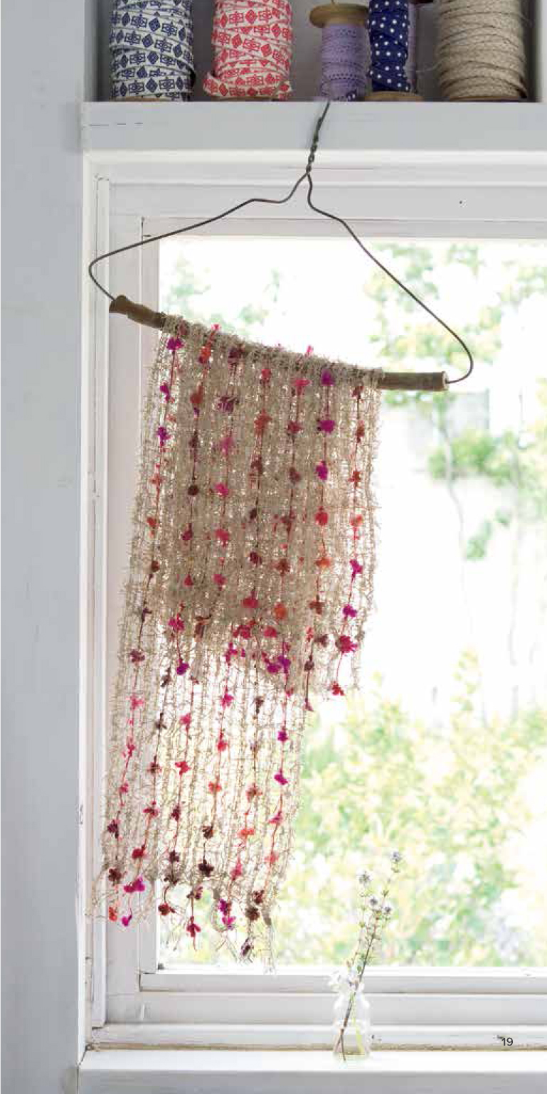 Festive pink pom-poms bloom from a framework of sheer beige yarn in this - photo 19