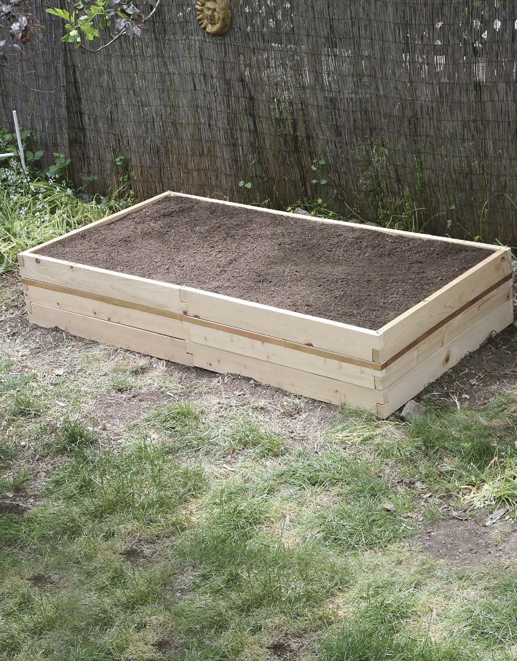 Once youve built the frame for your raised garden bed fill it with soil This - photo 9