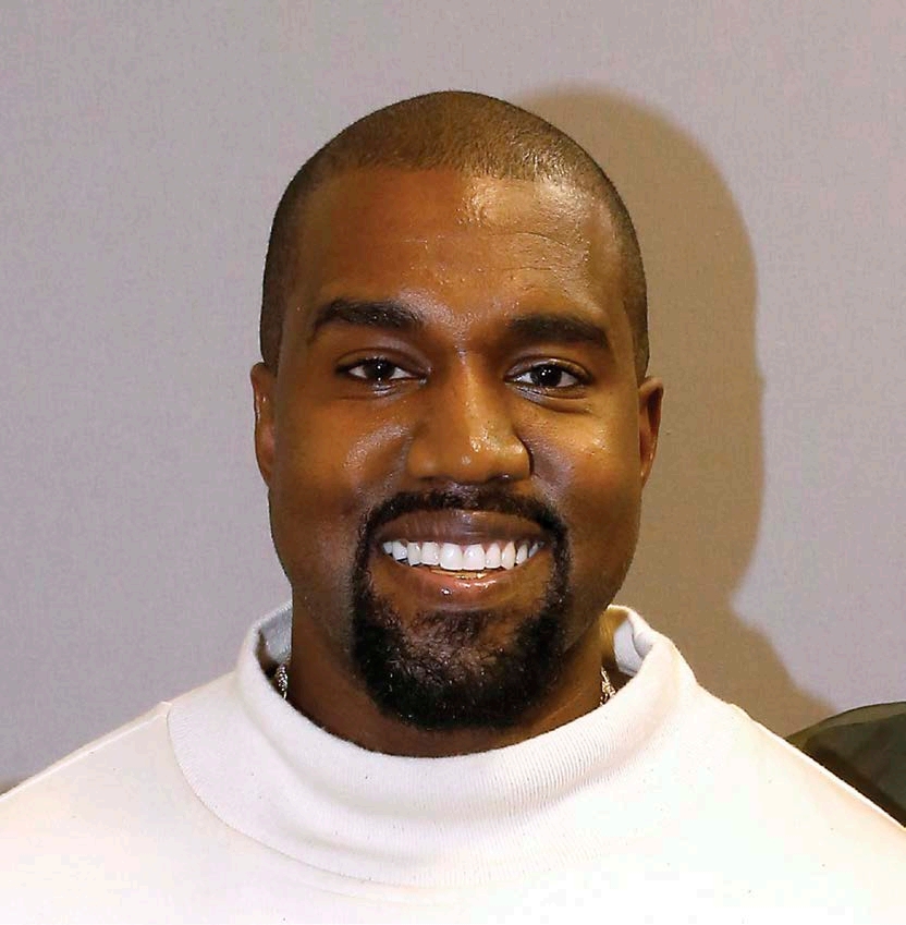 Kanye West smiles during a fashion show in Paris France He has found success - photo 2