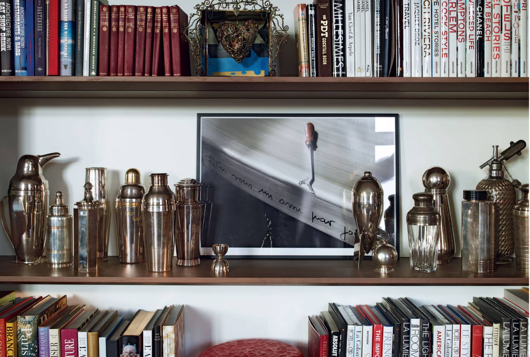 This bookshelf in Alexandre Ricards apartment hosts a collection of antique - photo 11