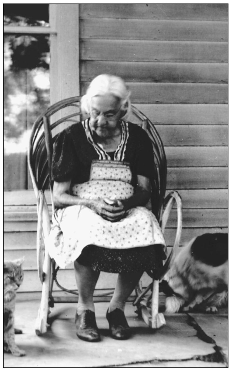 Hester Ann Crane sits in her hickory wickerrocker on her front porch with her - photo 10