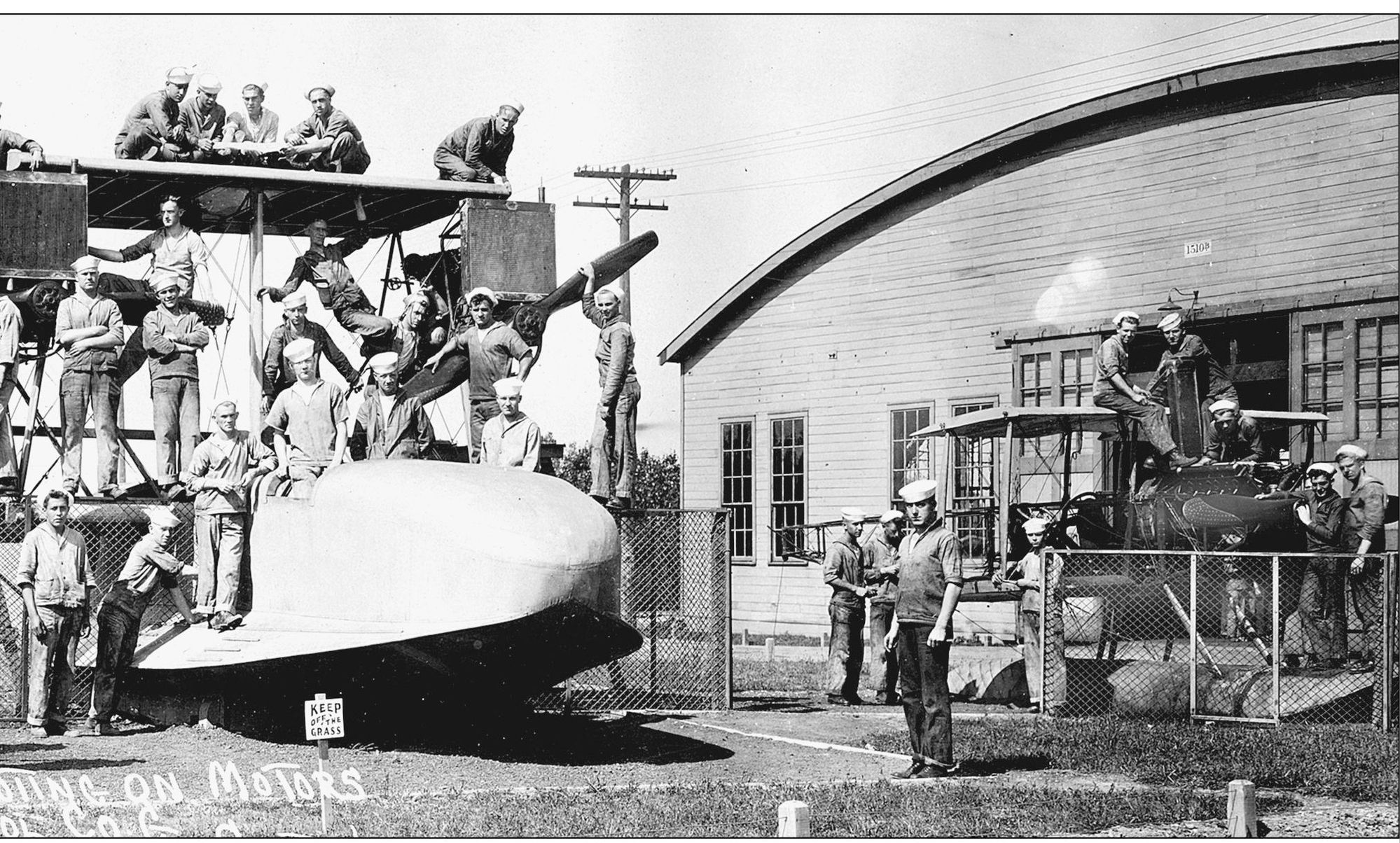 Courtesy of Great Lakes Naval Museum Sailors tow an N3N seaplane out - photo 8