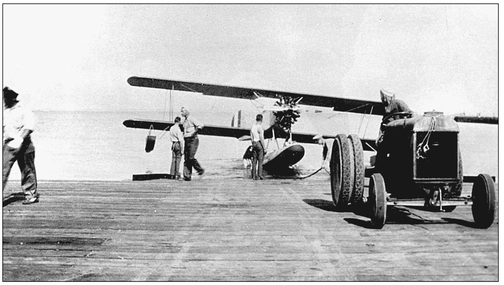 Sailors tow an N3N seaplane out of Lake Michigan onto the beach at Great Lakes - photo 9