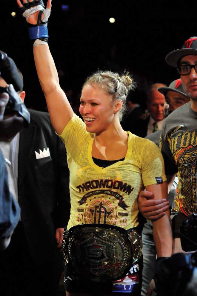 Opposite Ronda Rousey celebrates her win over Miesha Tate to capture the - photo 4