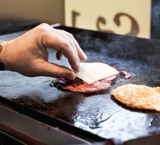 Putting a slice of cheese on top of the ham or smoked pork loin Putting - photo 10