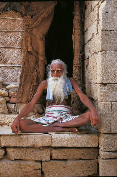 Mdhav Ds in front of his humble dwelling built against the ancient city walls - photo 3