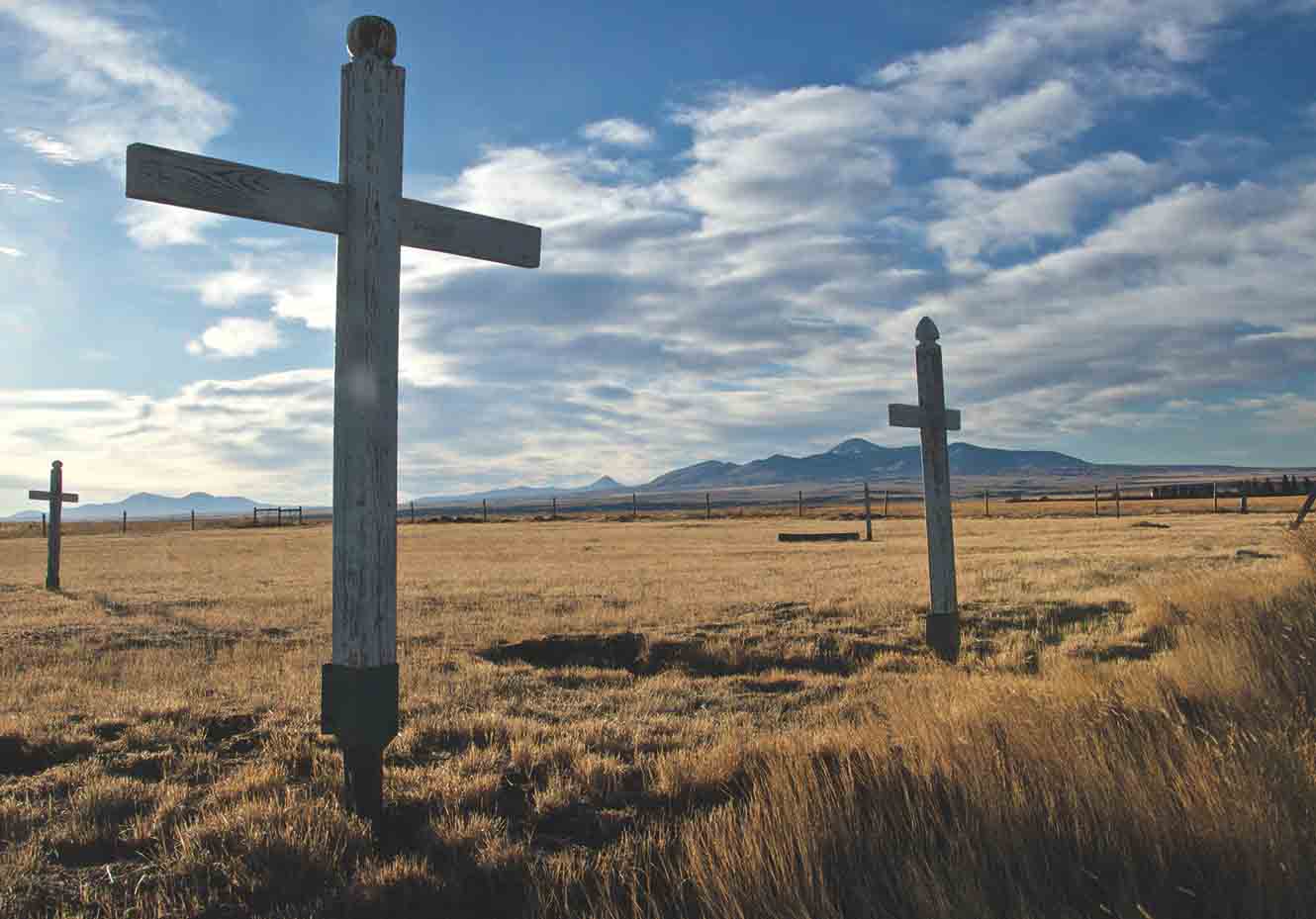 The forlorn graveyard at Masinasin looks southeast to the Sweet Grass Hills - photo 12