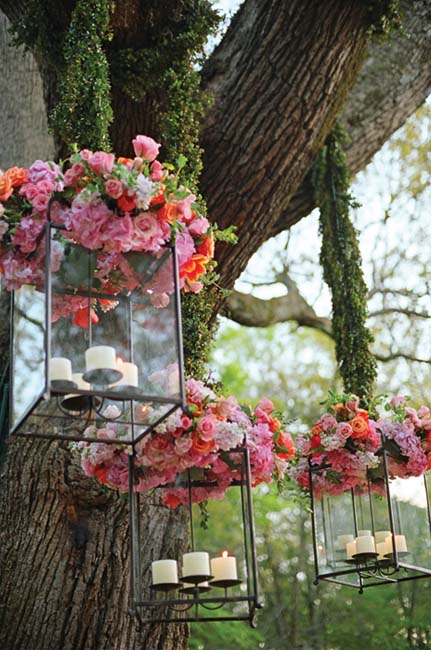 Lanterns topped with fresh flowers were hung from tree limbs by boxwood - photo 9