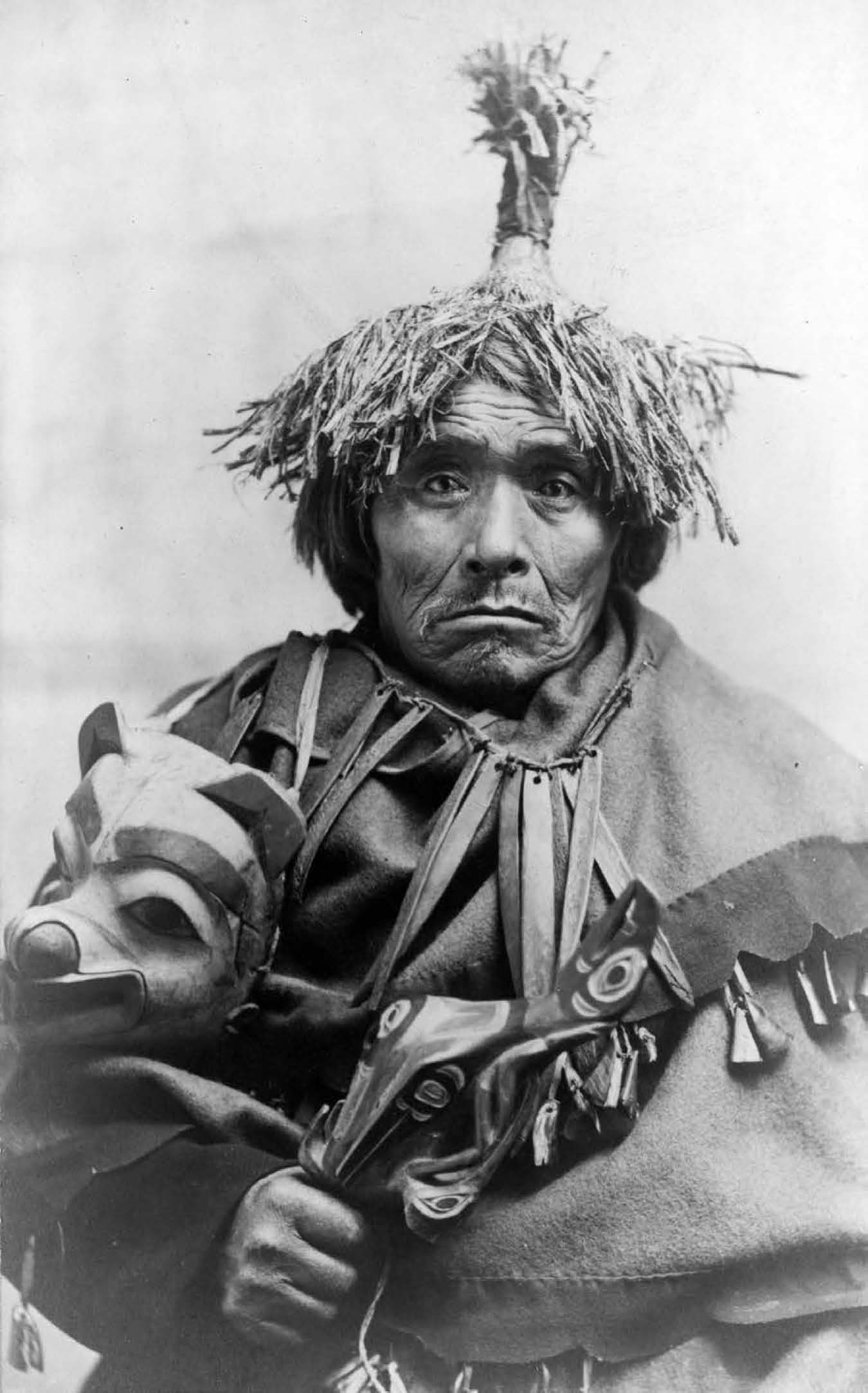 This shaman wears traditional garb and holds a mask used in ceremonies A - photo 4