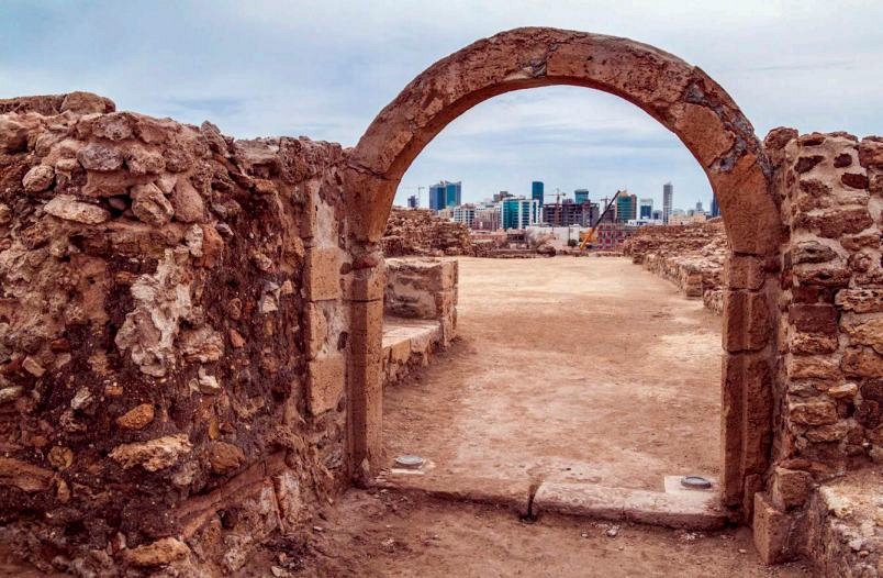 The ruins of Qalat al-Bahrain frame the Manama skyline in the distance Today - photo 4