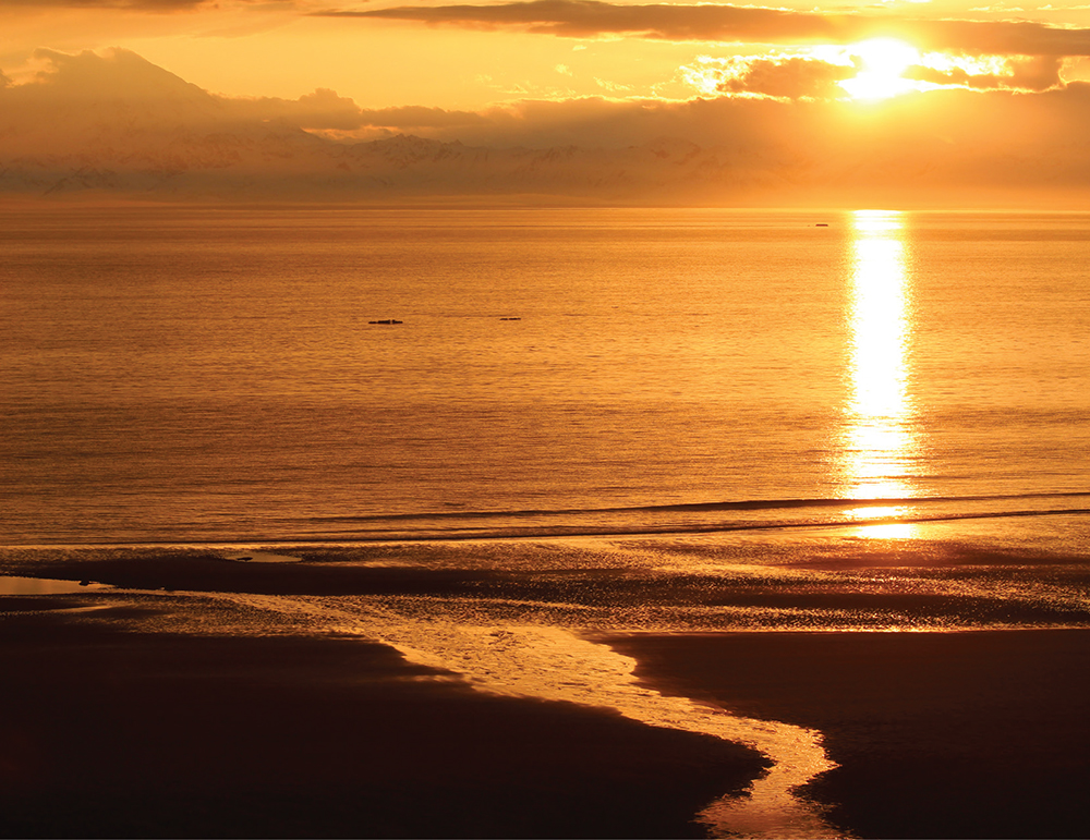 The sun sets on a calm day turning the water orange Nikis tent and our - photo 9