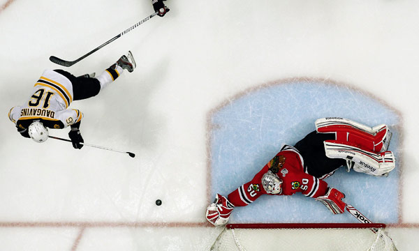 Blackhawks goalie Corey Crawford denies the Bruins Kaspars Daugavins in the - photo 6