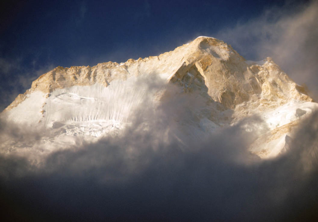 The west summit of Menlungtse as seen from base camp Jim States carrying a - photo 19