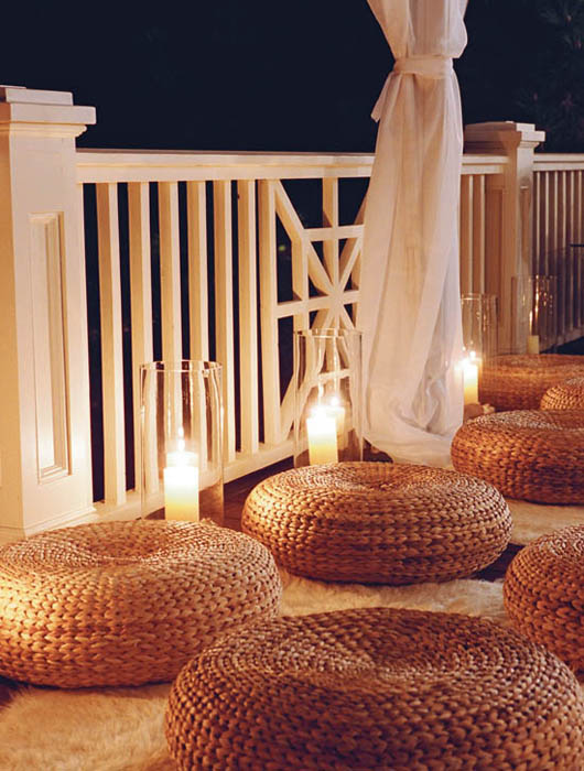 Seagrass floor ottomans atop white mohair rugs along with floor glass cylinders - photo 8