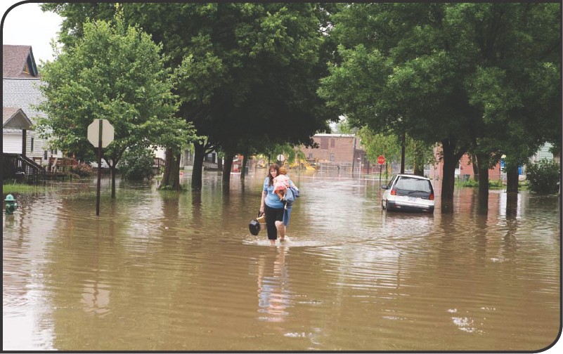 A woman wades through a flooded street in Cedar Rapids Iowa during the 2008 - photo 11