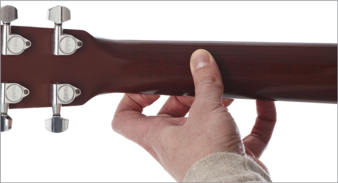 Place your thumb on the underside of the guitar neck Avoid letting the palm of - photo 8