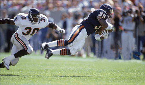 Bears fullback Neal Anderson dives for yardage in a 1992 game against the - photo 2