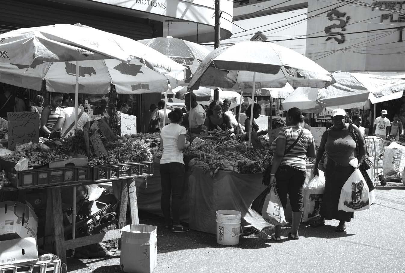 People buy local goods from farmers at a market in Port of Spain in Trinidad - photo 6