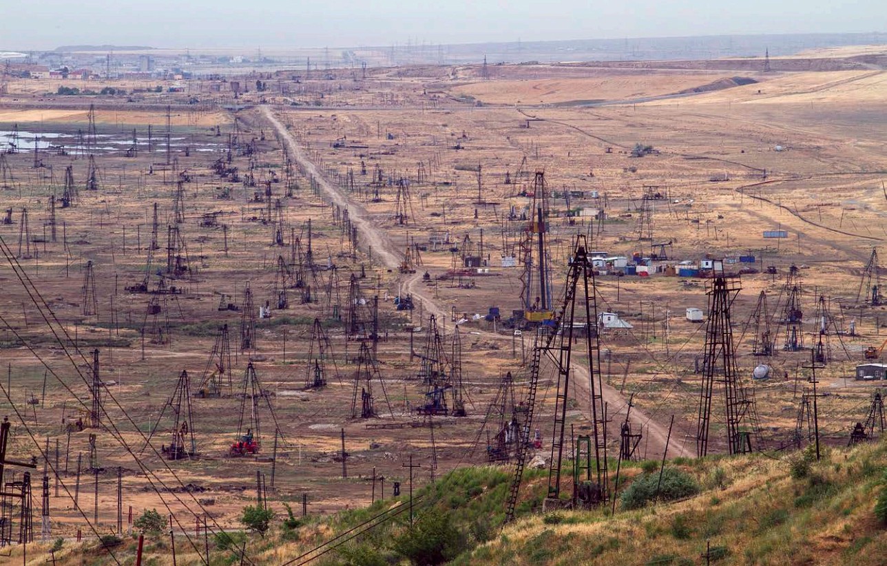 A multitude of rigs drill for oil in a large flat field in Azerbaijan All - photo 7