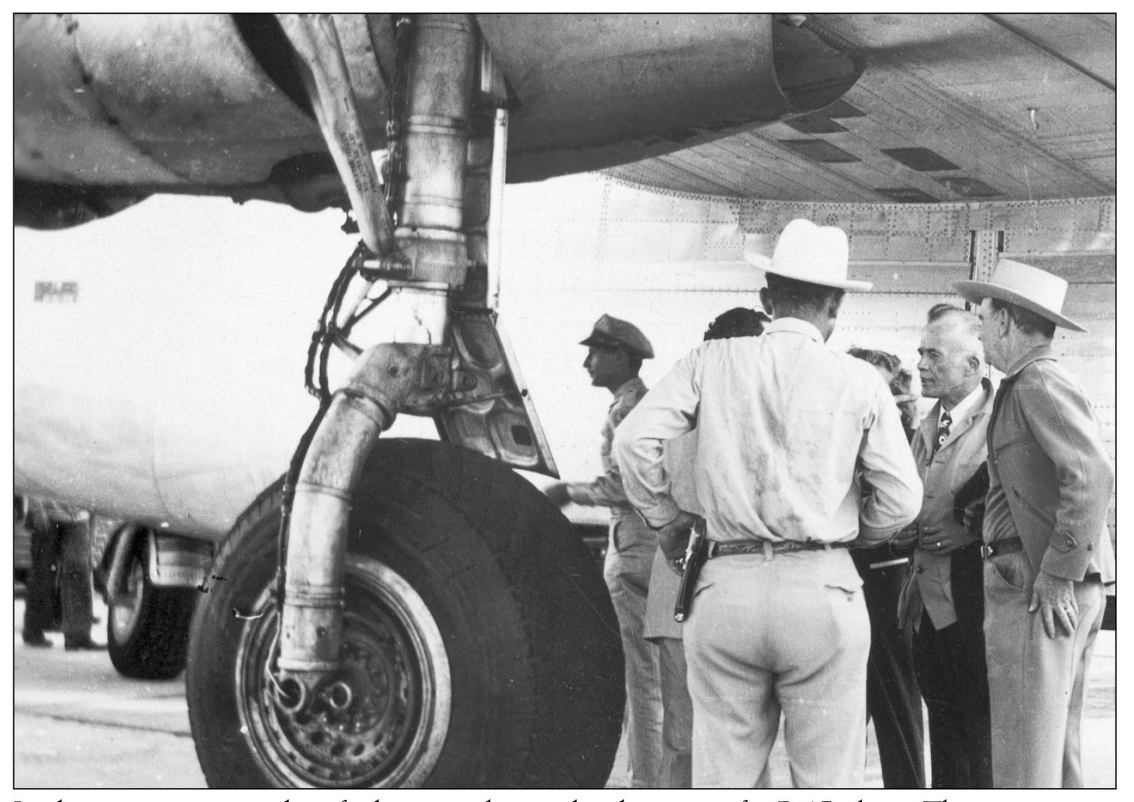 In this view some unidentified men gather under the wing of a B-17 plane This - photo 12