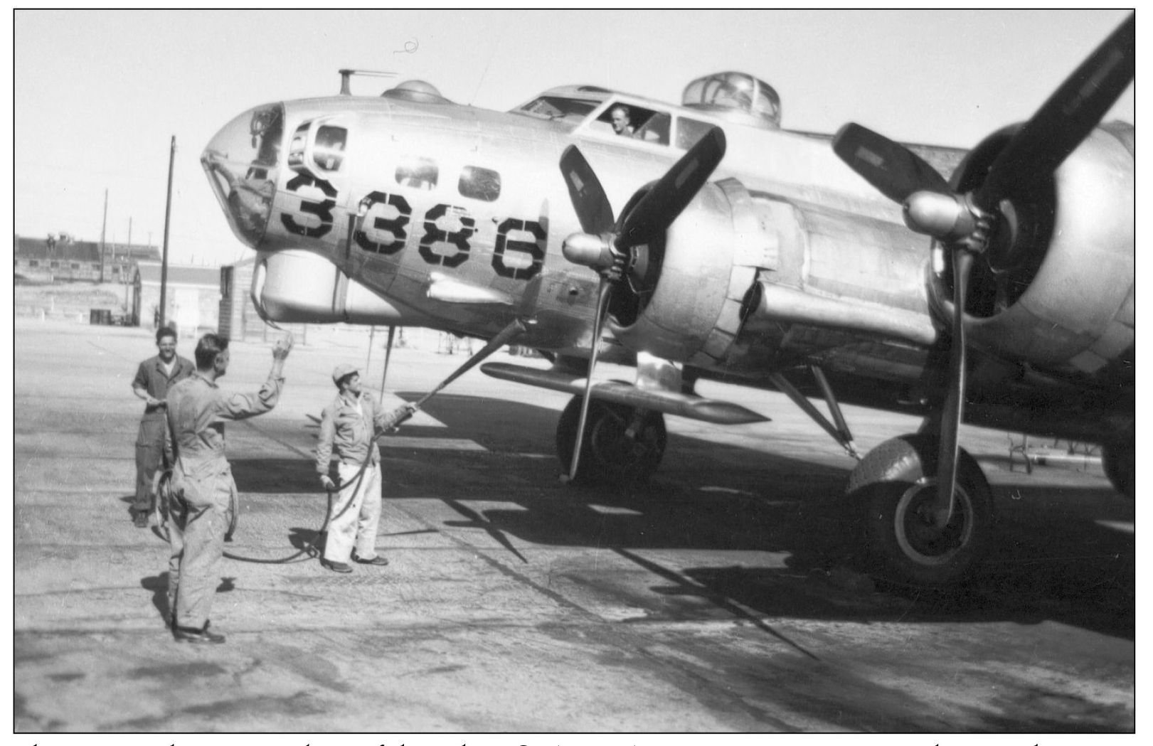 Three ground crew members of the 8th US Army Air Force service a B-17 plane - photo 13